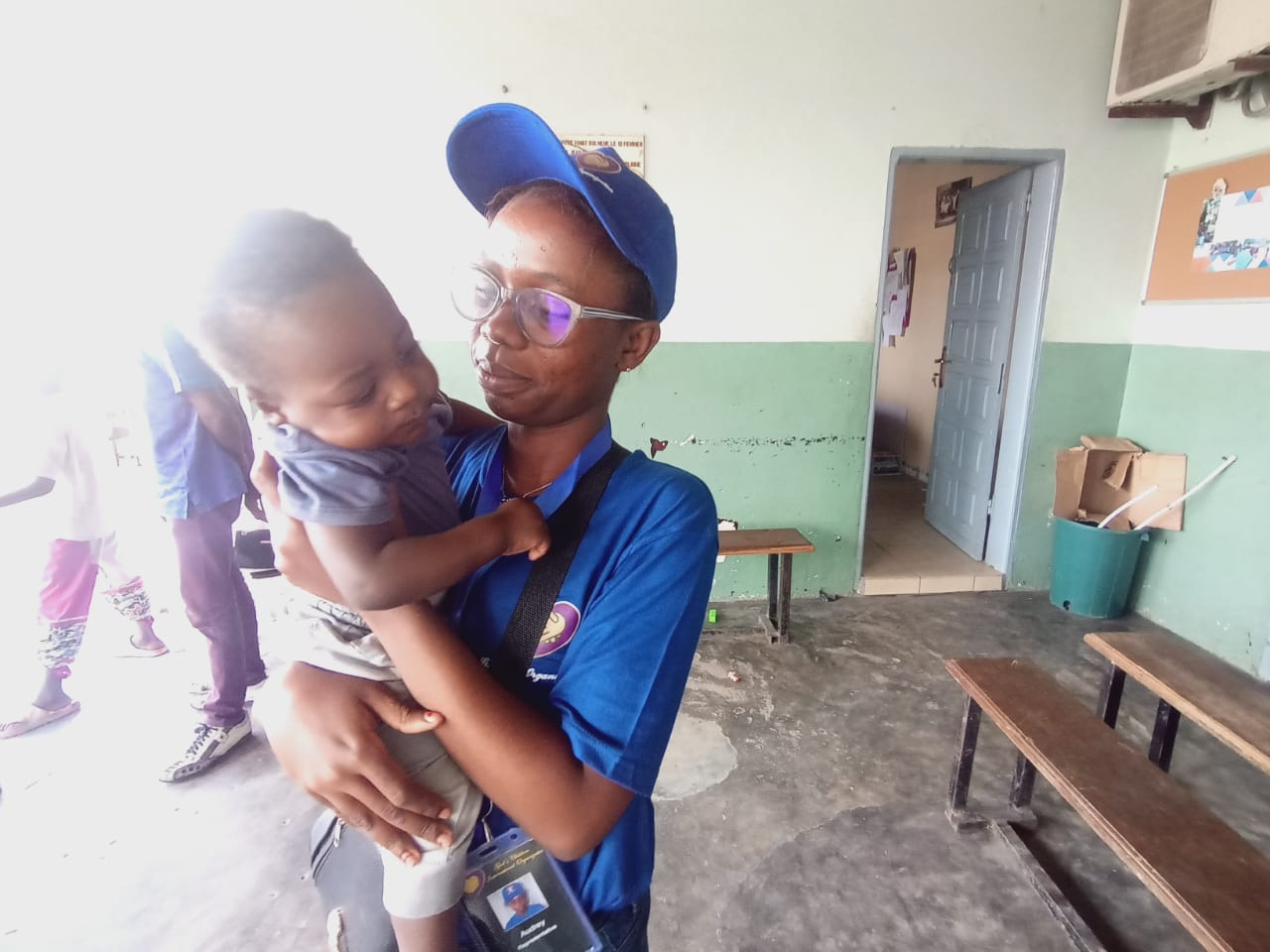 team member carrying child