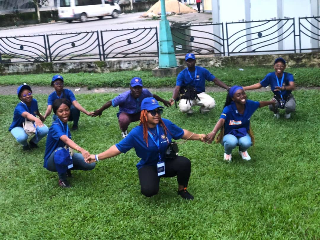 full team crouching and holding hands